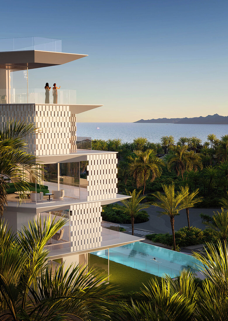 The tower rising from the pool deck, palms at its base.