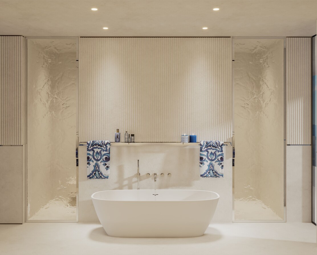 A bathroom with a freestanding tub and maiolica-print towels.