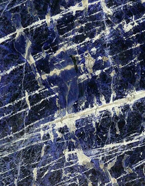 A sample of deep blue sodalite stone with white veining.