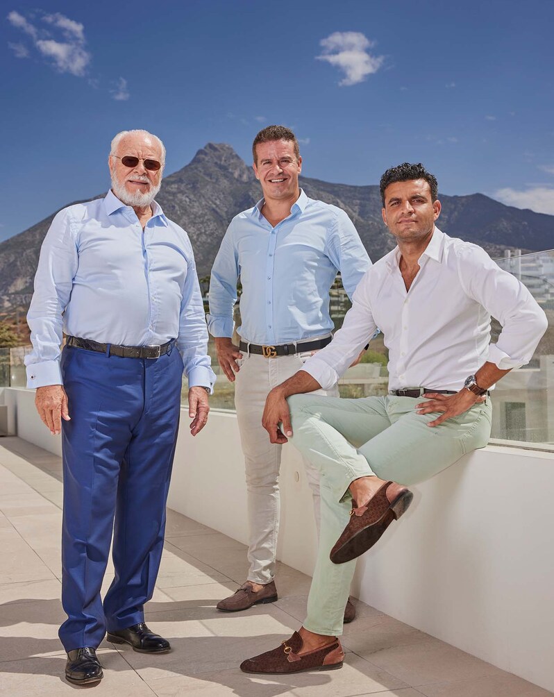 The Sierra Blanca Estates team on a terrace, the mountain behind.