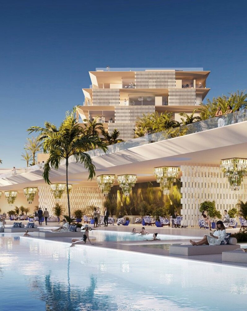 The residences stepping up the hillside above the pool deck.