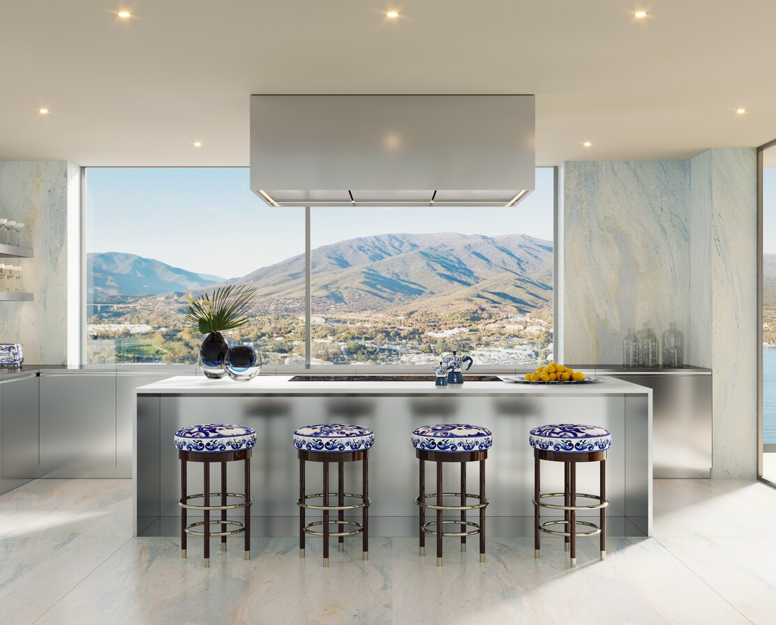 The kitchen: marble island, maiolica-topped barstools and the mountains beyond.