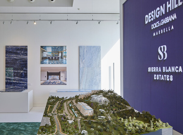The sales gallery: the masterplan model beneath the Design Hills and Sierra Blanca Estates marks.