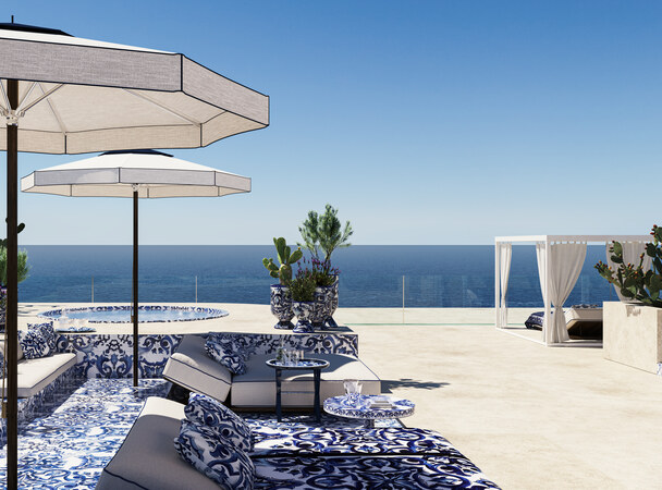 Rooftop terrace with parasols and a jacuzzi looking out to the sea.